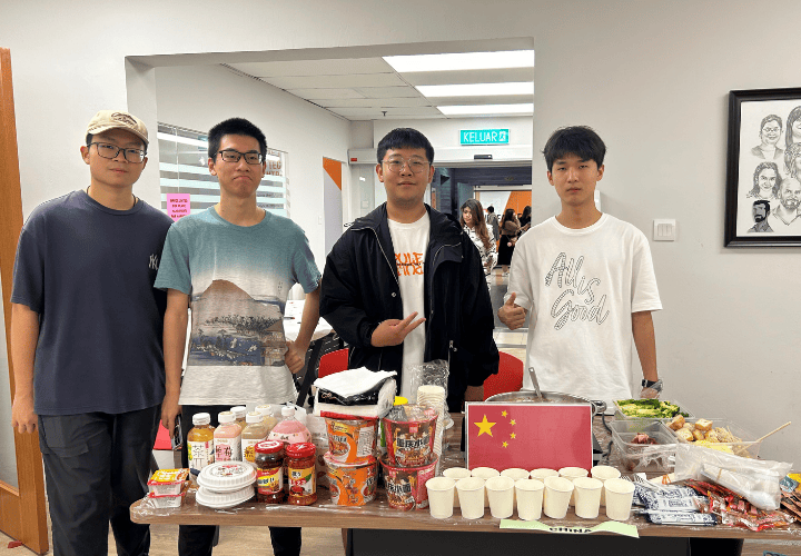 A group of students at the China food and culture booth during an ELS cultural exchange activity