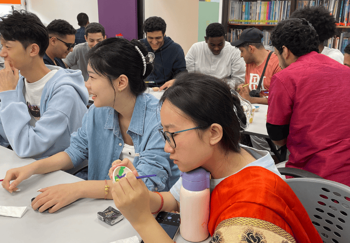 A group of ELS students painting lamps for Deepavali 